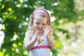 Happy curly toddler girl clapping with her palms