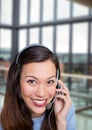 Happy customer care representative woman against building background Royalty Free Stock Photo