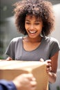 Happy customer, delivery and giving cardboard box while excited for courier service. African woman outdoor to collect a Royalty Free Stock Photo