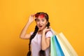 Indian lady in glasses holding colorful shopping bags at studio Royalty Free Stock Photo