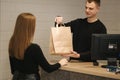 Happy customer with shopping bag in clothing room Royalty Free Stock Photo