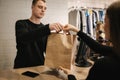 Happy customer with shopping bag in clothing room Royalty Free Stock Photo