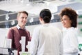 Happy customer talking with two helpful pharmacists in a contemporary drugstore Royalty Free Stock Photo