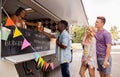 Happy customers queue at food truck Royalty Free Stock Photo