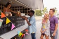 Happy customers queue at food truck