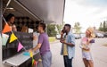 Happy customers queue at food truck Royalty Free Stock Photo