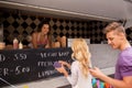 Happy customers queue at food truck Royalty Free Stock Photo