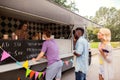 Happy customers queue at food truck Royalty Free Stock Photo