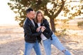 Happy and cute adorable adult couple of millennial hipsters, man with woman girlfriend walking, have fun play, laugh,smile and