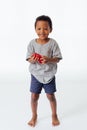 Happy and cute African American boy playing his toy isolated in