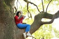 Happy cute Asian Chinese nature beautiful woman girl in a spring park enjoy free time read book Royalty Free Stock Photo