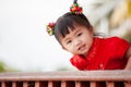 Happy cute asian child girl in chinese tradition dress smiling and wishing you a happy in Chinese New Year Royalty Free Stock Photo