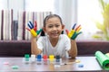 Happy cute asian little girl with colorful painted hands at home  education concept Royalty Free Stock Photo