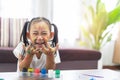 Happy cute asian little girl with colorful painted hands at home education concept Royalty Free Stock Photo