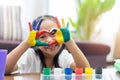 Happy cute asian little girl with colorful painted on hands and make a heart shape, Royalty Free Stock Photo