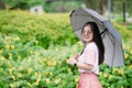 Happy cute asian teen with umbrella pretect from rain in raining season or uv sun light in summer