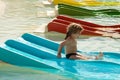 Happy cute baby boy slides from blue waterslide Royalty Free Stock Photo