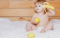 Happy cute baby eats apple and banana. Royalty Free Stock Photo
