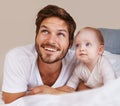 Happy, cute and baby with father on bed relaxing, playing and bonding together at home. Smile, love and young dad laying Royalty Free Stock Photo