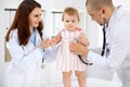 Happy cute baby at health exam at doctor`s office. Medicine and health care concept Royalty Free Stock Photo