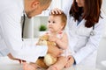 Happy cute baby at health exam at doctor`s office. Medicine and health care concept Royalty Free Stock Photo