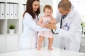 Happy cute baby at health exam at doctor`s office. Medicine and health care concept Royalty Free Stock Photo