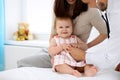 Happy cute baby with mother at health exam at doctor`s office. Medicine and health care concept Royalty Free Stock Photo