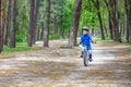 Happy cute blond kid boy having fun his first bike on sunny summer day, outdoors. child making sports. Active leisure for childre Royalty Free Stock Photo