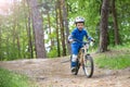 Happy cute blond kid boy having fun his first bike on sunny summer day, outdoors. child making sports. Active leisure for childre Royalty Free Stock Photo