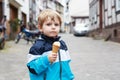 Happy cute boy eating ice cream in cone. Royalty Free Stock Photo