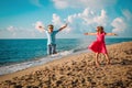 Happy cute boy and girl enjoy play jump on beach Royalty Free Stock Photo