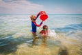 Happy boy and girl play on beach, kids splash water and have fun Royalty Free Stock Photo