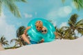 Happy cute boy and girl play with floatie on beach Royalty Free Stock Photo