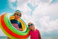 Happy cute boy and girl play with floaties on beach Royalty Free Stock Photo