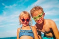 Happy cute boy and girl play with water on beach Royalty Free Stock Photo