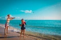 Happy cute boy and girl play with water gun on beach Royalty Free Stock Photo