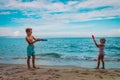 happy cute boy and girl play with water guns on beach Royalty Free Stock Photo