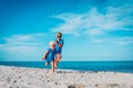 Happy cute boy and girl running on beach Royalty Free Stock Photo