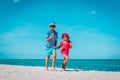 Happy cute boy and girl running on beach Royalty Free Stock Photo