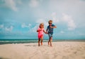 Happy cute boy and girl running on beach Royalty Free Stock Photo