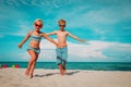 Happy cute boy and girl running on beach Royalty Free Stock Photo