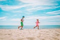 Happy cute boy and girl running on beach, kids enjoy vacation at sea Royalty Free Stock Photo