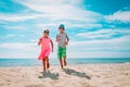 Happy cute boy and girl running on beach, kids enjoy vacation at sea Royalty Free Stock Photo