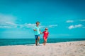 Happy cute boy and girl running on beach Royalty Free Stock Photo