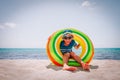 Happy cute boy play with floatie on beach Royalty Free Stock Photo