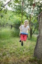 Happy cute boy on swing in garden Royalty Free Stock Photo