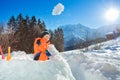 Happy cute boy throw snowball standing in the snow fortress Royalty Free Stock Photo