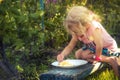 Happy cute child girl eating fresh fruits in summer garden concept healthy eating countryside lifestyle Royalty Free Stock Photo