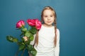 Happy cute child girl holding rose flowers as present for mother or father day Royalty Free Stock Photo