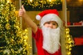 Happy cute child in Santa hat have a Christmas and show ok. New year kids Christmas concept. Royalty Free Stock Photo